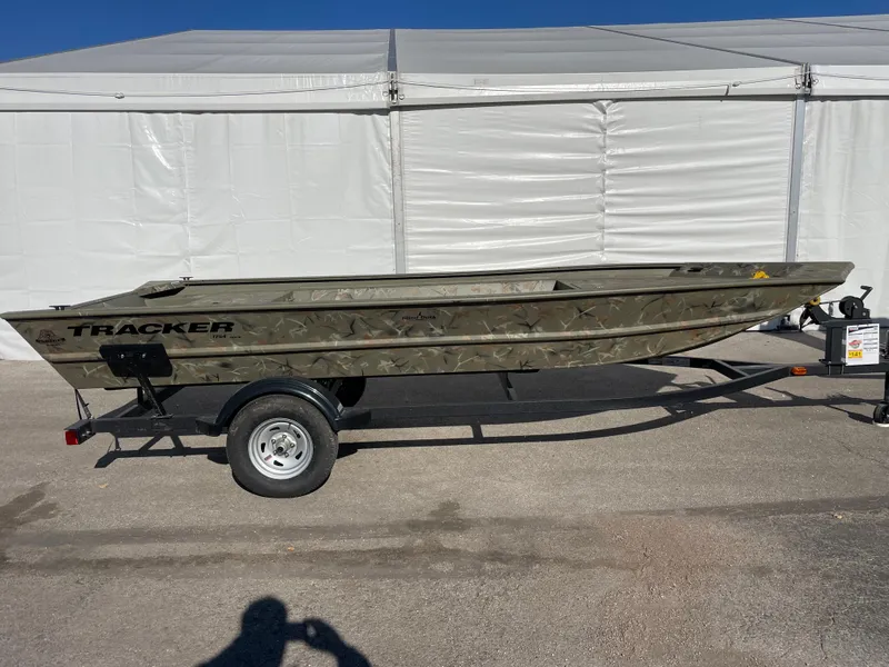 Slide: The Image of 2024 Tracker Grizzly 1754 Jon boat on trailer, side view. - 2