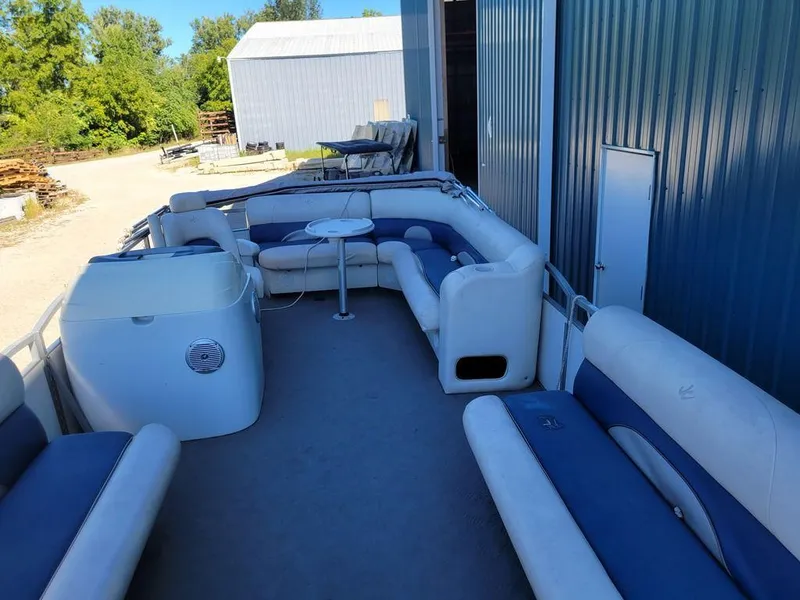 Slide: The Image of 2008 Custom Neptune 23 pontoon boat with blue and white seating. - 10