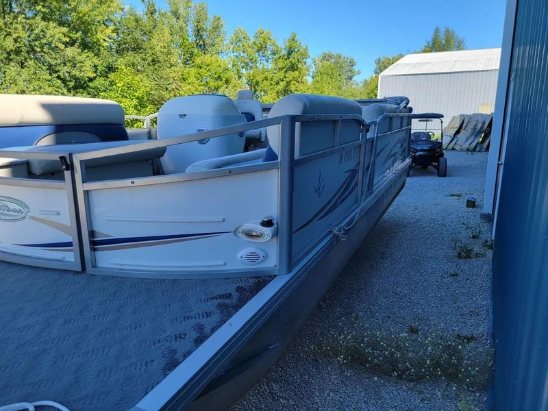 Slide: The Image of Custom Neptune 23 pontoon boat, 2008 model, docked near a blue building. - 4