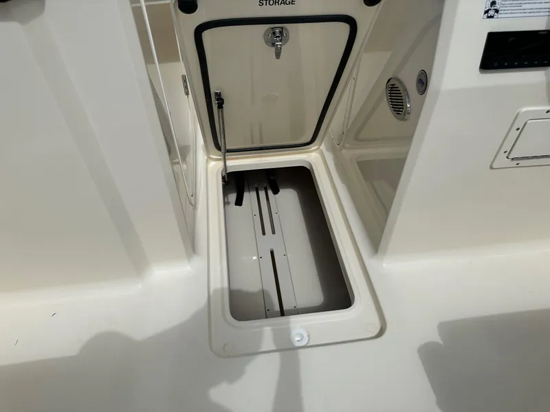 Slide: The Image of 2024 Scout 215 Dorado boat storage compartment with open hatch. - 12