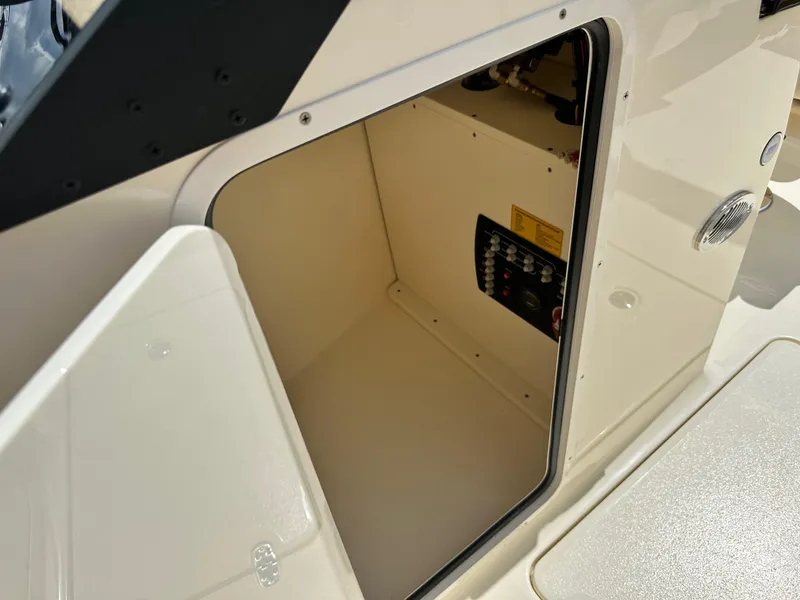 Slide: The Image of 2024 Scout 215 Dorado storage compartment with control panel. - 13