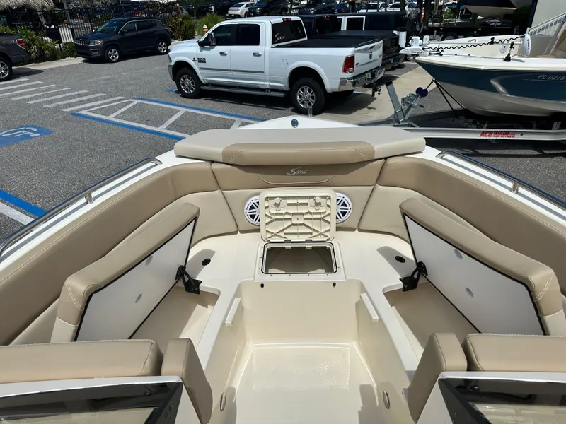 Slide: The Image of 2024 Scout 215 Dorado boat interior with beige seating and storage compartments. - 16