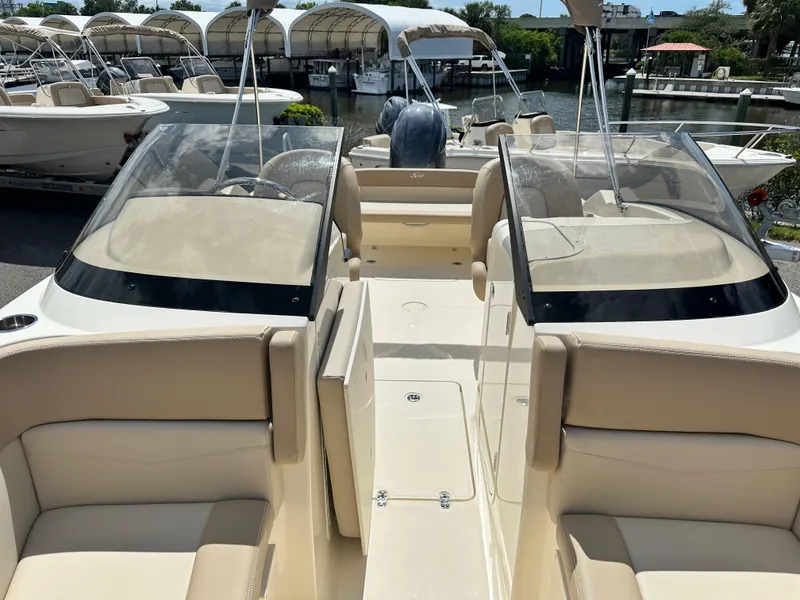 Slide: The Image of 2024 Scout 215 Dorado boat interior with beige seating and dual consoles. - 17