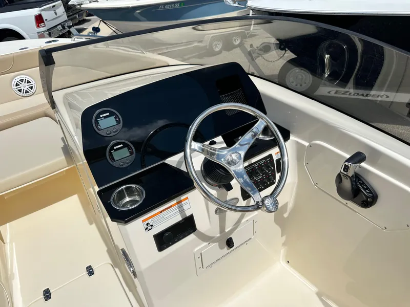 Slide: The Image of 2024 Scout 215 Dorado boat dashboard with steering wheel and control panel. - 5