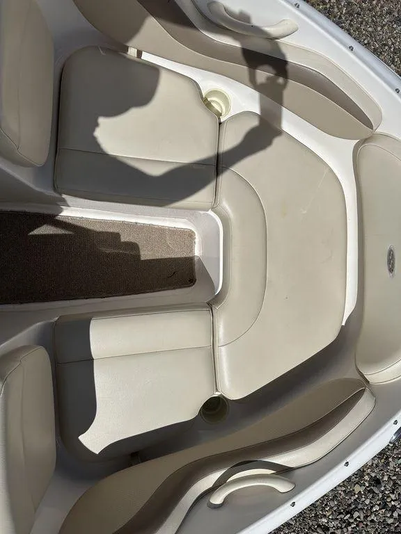 Slide: The Image of 2004 Chaparral 190SSI boat interior with beige seating and carpet. - 12