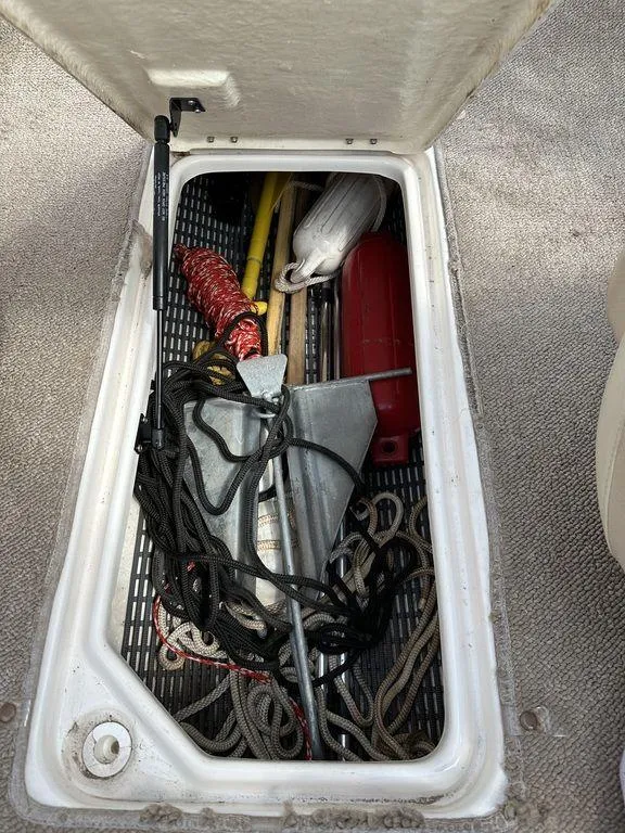 Slide: The Image of Storage compartment of a 2004 Chaparral 190SSI boat with anchor and ropes. - 13