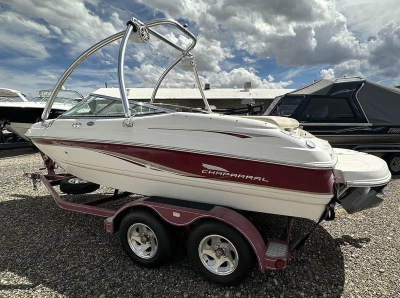 Slide: The Image of 2004 Chaparral 190SSI boat on a trailer under a cloudy sky. - 14