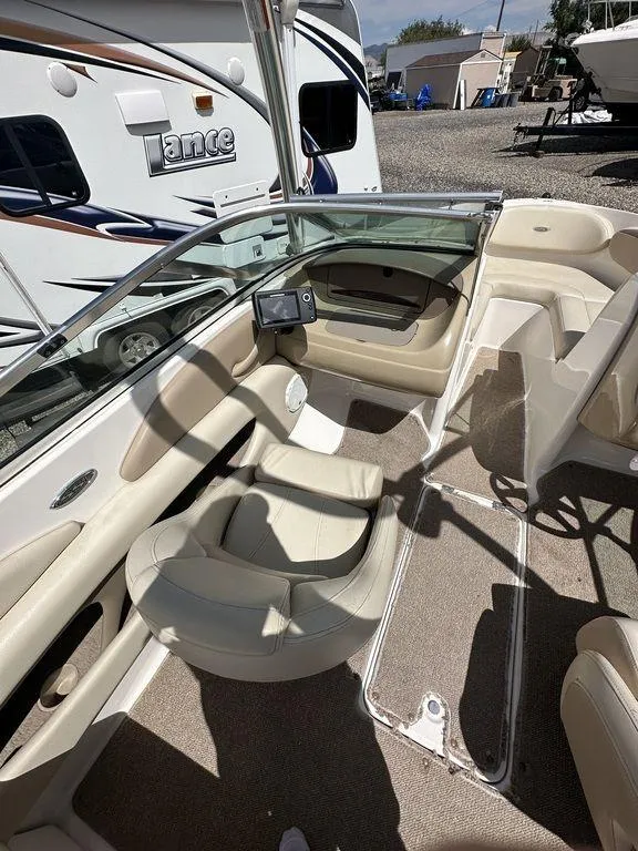 Slide: The Image of 2004 Chaparral 190SSI boat interior with beige seating and glass windshield. - 3