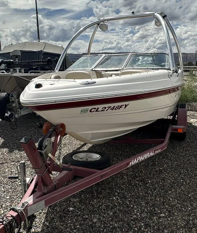 Slide: The Image of 2004 Chaparral 190SSI boat on a trailer, parked outdoors. - 9