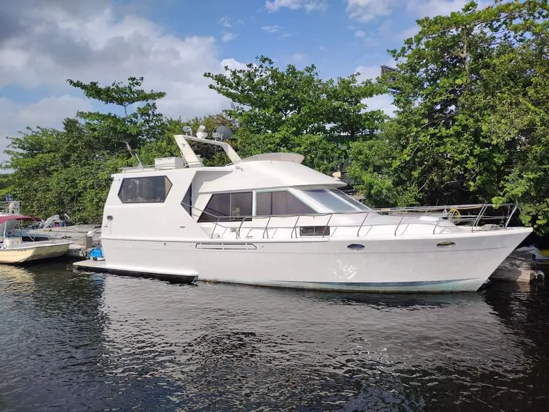 Slide: The Image of 1989 MedYacht Morocco docked near lush greenery. - 0