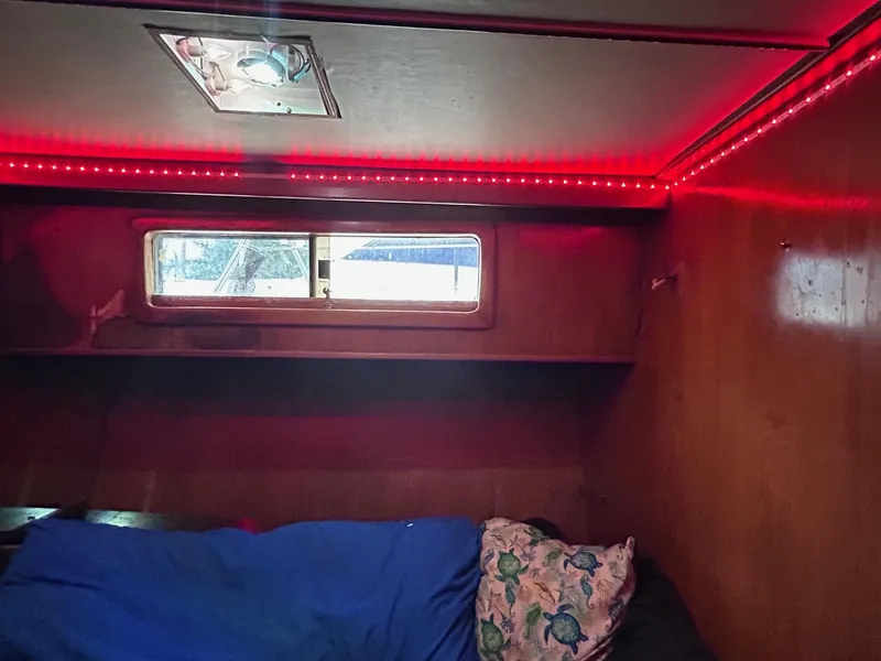 Slide: The Image of 1989 MedYacht Morocco cabin interior with red LED lighting and window. - 38