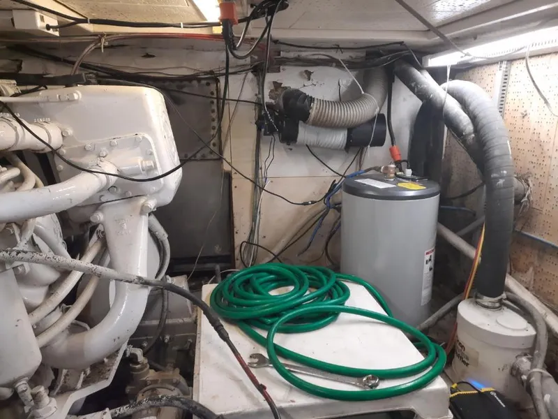 Slide: The Image of Engine room of a 1989 MedYacht Morocco with hoses and machinery. - 4