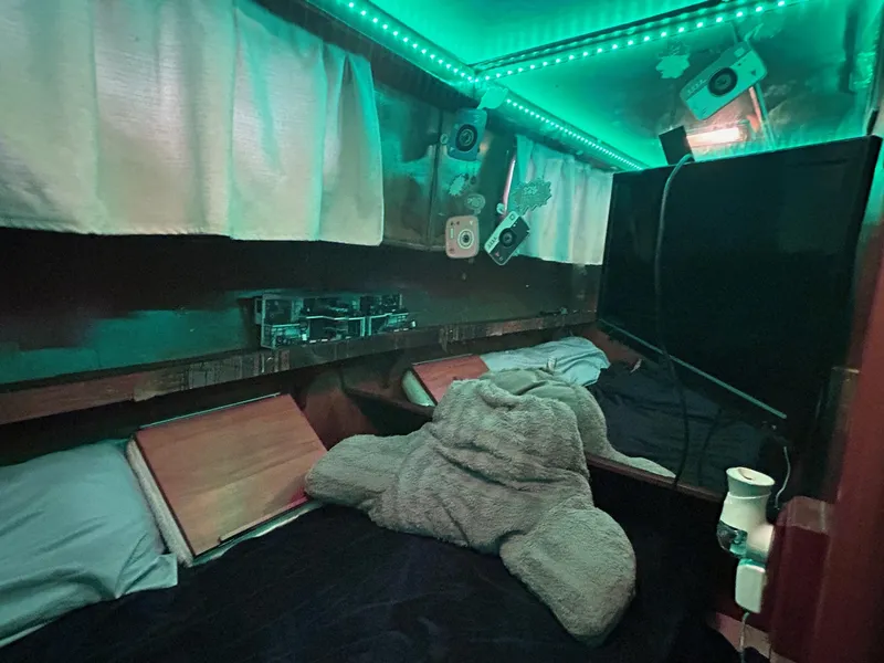 Slide: The Image of Cozy cabin interior of 1989 MedYacht Morocco with ambient green lighting. - 42