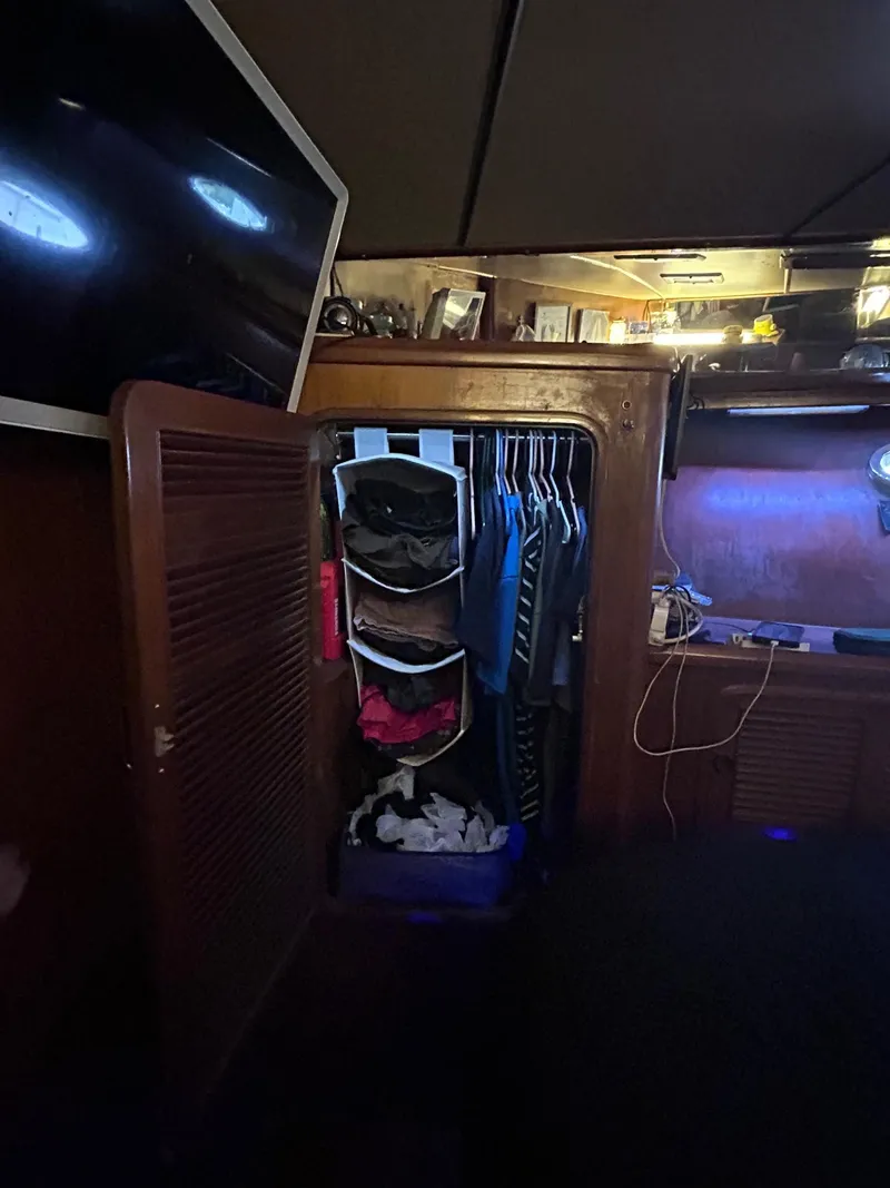 Slide: The Image of Interior closet of 1989 MedYacht Morocco with hanging clothes and storage bins. - 49