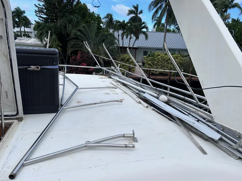 Slide: The Image of 1989 MedYacht Morocco deck with scattered metal rods and tropical background. - 8