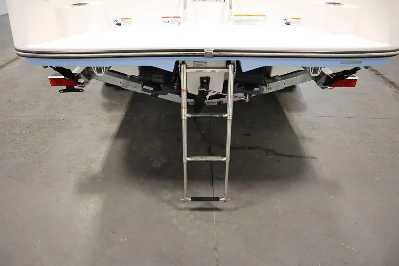 Slide: The Image of 2024 Yamaha Boats 222 FSH Sport with extended swim ladder on trailer. - 11