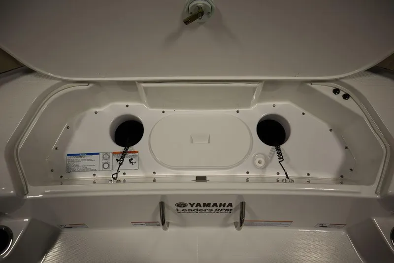 Slide: The Image of 2024 Yamaha Boats 222 FSH Sport storage compartment with dual cup holders. - 12