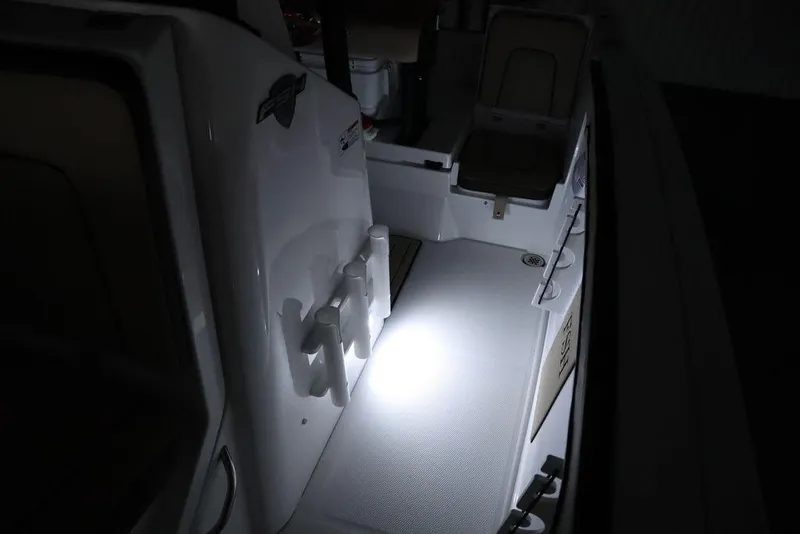 Slide: The Image of 2024 Yamaha Boats 222 FSH Sport interior with illuminated deck area. - 16