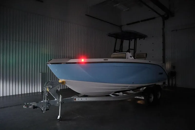 Slide: The Image of 2024 Yamaha Boats 222 FSH Sport in a dimly lit garage on a trailer. - 18