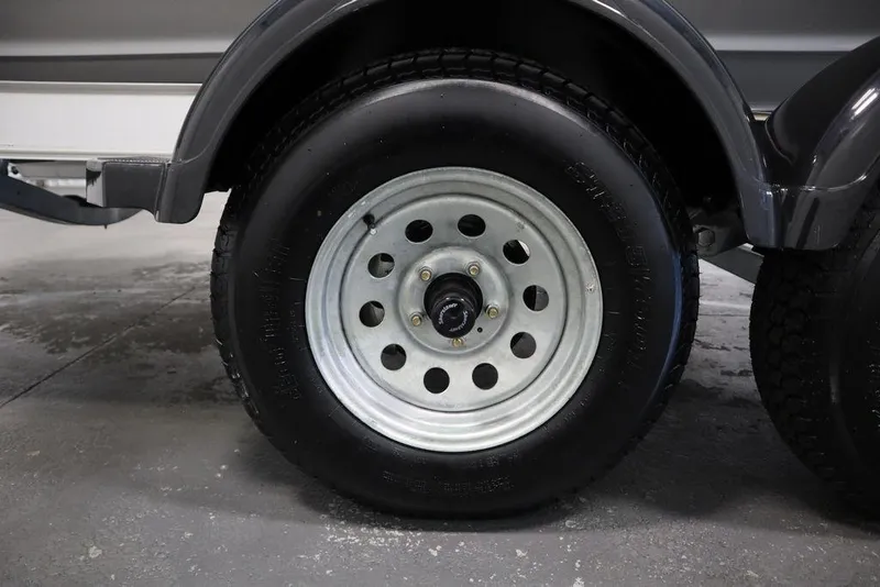 Slide: The Image of Close-up of a 2024 Yamaha Boats 222 FSH Sport trailer wheel. - 19