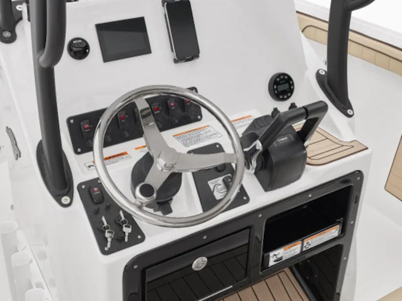 Slide: The Image of 2024 Yamaha Boats 222 FSH Sport dashboard with steering wheel and controls. - 2