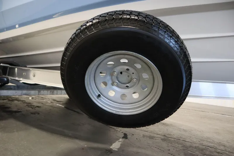 Slide: The Image of Close-up of a 2024 Yamaha Boats 222 FSH Sport trailer wheel. - 22