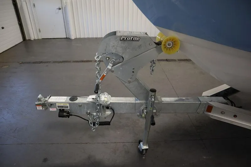 Slide: The Image of Trailer hitch of 2024 Yamaha Boats 222 FSH Sport in a garage setting. - 23