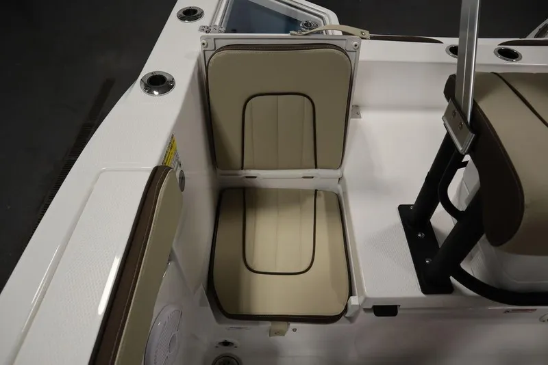 Slide: The Image of 2024 Yamaha Boats 222 FSH Sport interior seating detail, beige and white upholstery. - 24