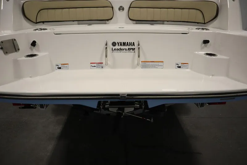 Slide: The Image of 2024 Yamaha Boats 222 FSH Sport rear view with seating and storage compartments. - 27