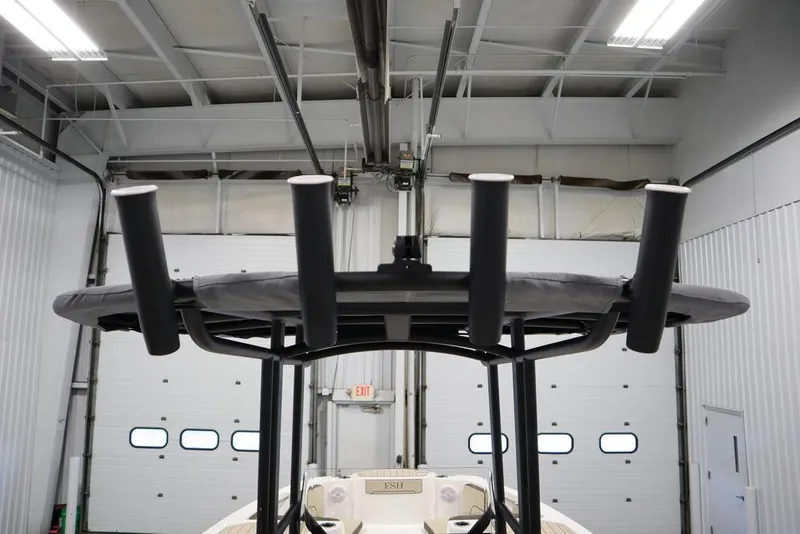 Slide: The Image of 2024 Yamaha Boats 222 FSH Sport fishing rod holders in a garage. - 28