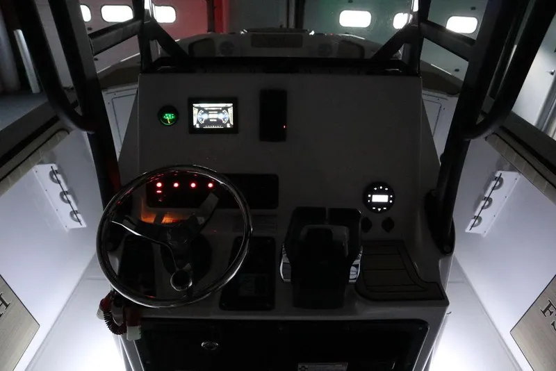 Slide: The Image of 2024 Yamaha Boats 222 FSH Sport dashboard with illuminated controls and steering wheel. - 3