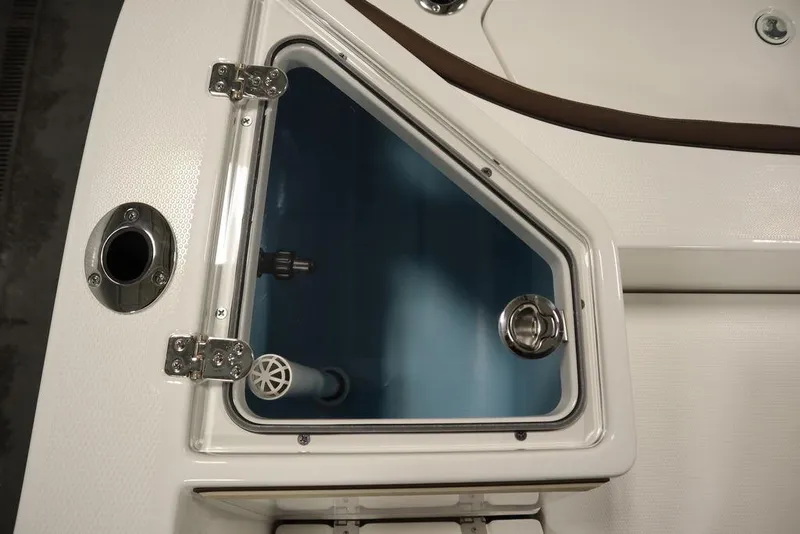 Slide: The Image of 2024 Yamaha Boats 222 FSH Sport livewell compartment with clear lid and stainless steel fittings. - 30