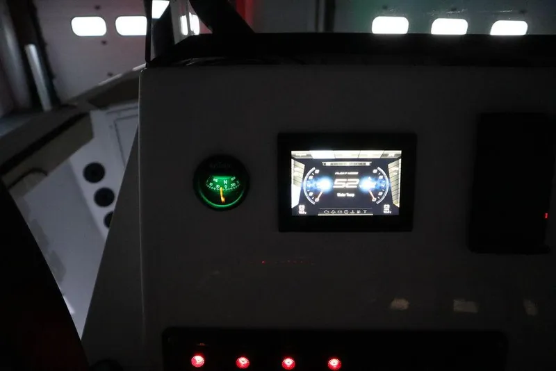 Slide: The Image of 2024 Yamaha Boats 222 FSH Sport dashboard with digital display and controls. - 4