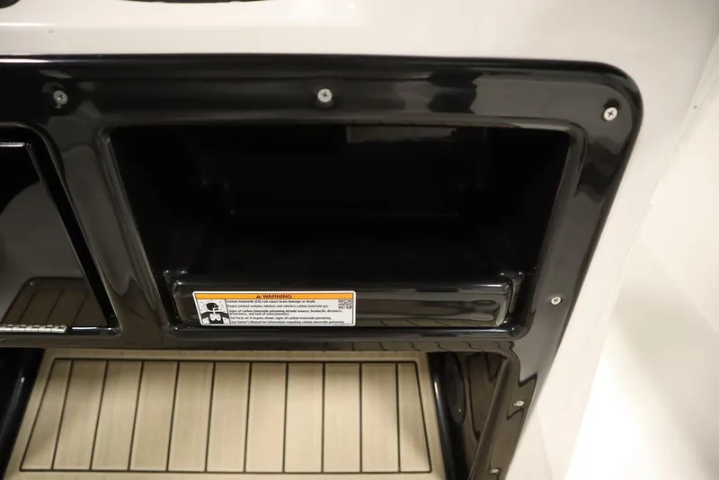 Slide: The Image of Storage compartment on 2024 Yamaha Boats 222 FSH Sport, featuring sleek black trim. - 40