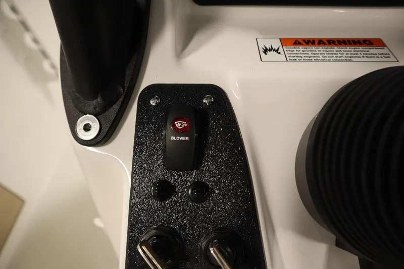 Slide: The Image of Close-up of 2024 Yamaha Boats 222 FSH Sport blower switch and warning label. - 43