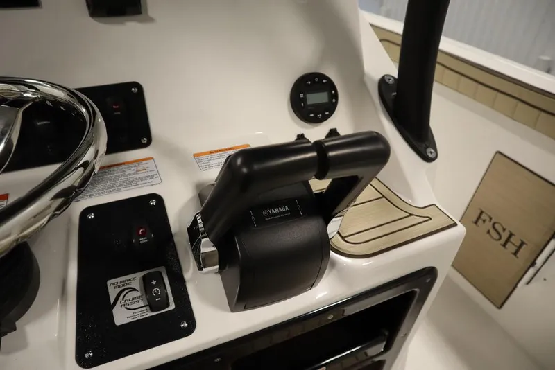Slide: The Image of 2024 Yamaha Boats 222 FSH Sport control panel with steering wheel and throttle. - 44