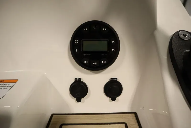Slide: The Image of 2024 Yamaha Boats 222 FSH Sport dashboard controls and outlets. - 46