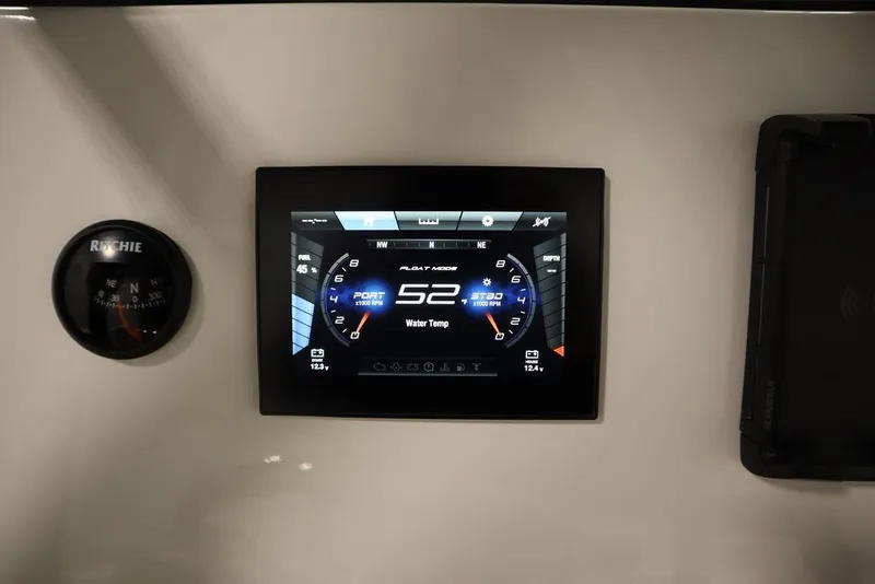 Slide: The Image of 2024 Yamaha Boats 222 FSH Sport dashboard with digital display and compass. - 48