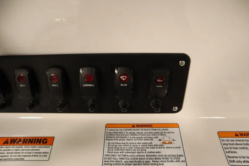 Slide: The Image of Control panel of 2024 Yamaha Boats 222 FSH Sport with warning labels. - 49