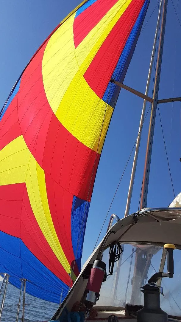 Slide: The Image of Colorful sail on a 2005 Beneteau First 44.7 yacht against a clear blue sky. - 10