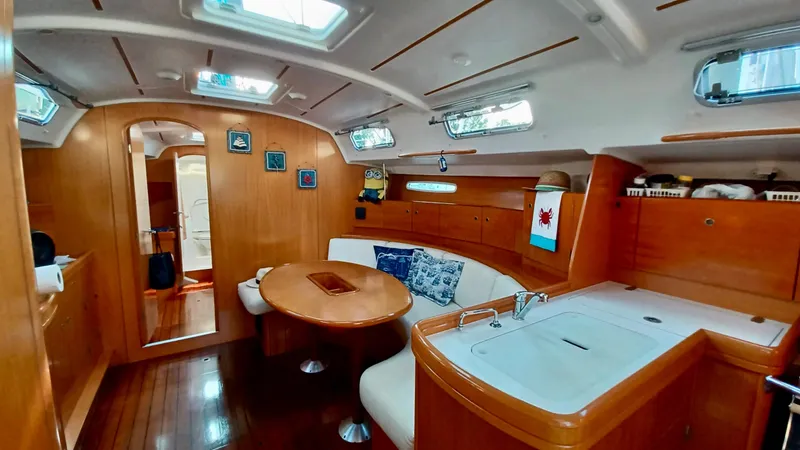 Slide: The Image of Luxurious interior of a 2005 Beneteau First 44.7 yacht with wood finish and cozy seating. - 11