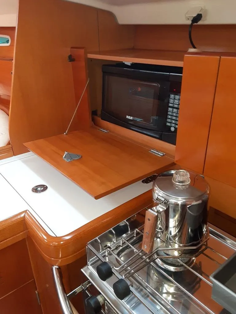 Slide: The Image of 2005 Beneteau First 44.7 yacht kitchen with microwave and stove. - 17