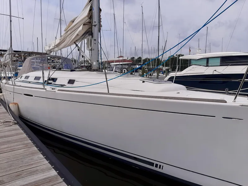 Slide: The Image of 2005 Beneteau First 44.7 sailboat docked at marina, side view. - 3