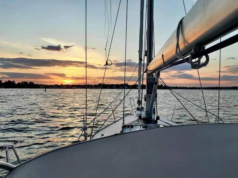 Slide: The Image of Sailing on a 2005 Beneteau First 44.7 at sunset, serene waters and vibrant sky. - 8