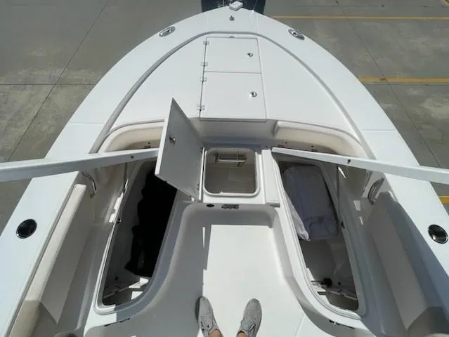 Slide: The Image of 2016 Robalo 246 Cayman boat bow with open storage compartments. - 12