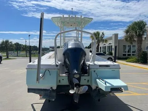 Slide: The Image of 2016 Robalo 246 Cayman boat with outboard motor in a parking lot. - 4