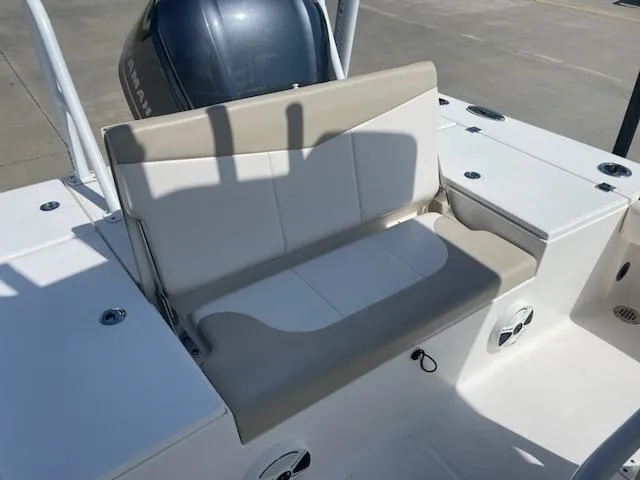 Slide: The Image of 2016 Robalo 246 Cayman boat seating area with beige and white cushions. - 6