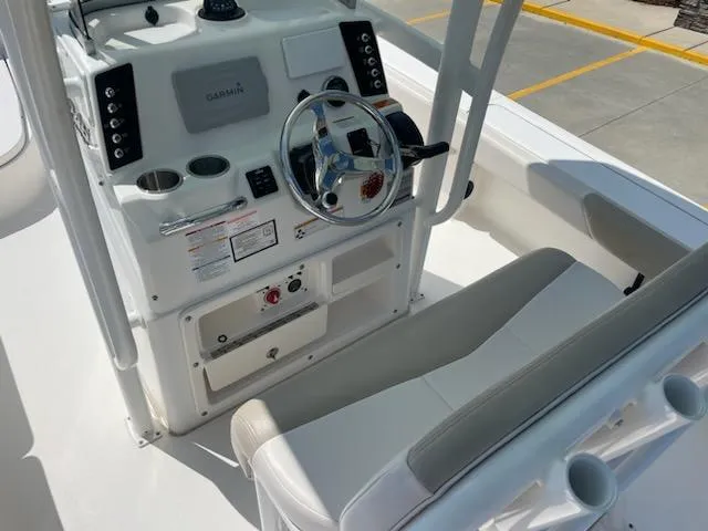 Slide: The Image of 2016 Robalo 246 Cayman boat console with steering wheel and seating. - 10
