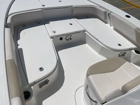 Slide: The Image of 2016 Robalo 246 Cayman boat interior with seating and storage compartments. - 11