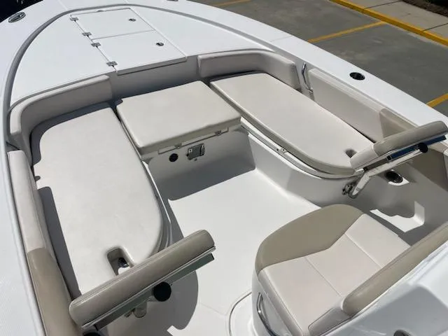 Slide: The Image of 2016 Robalo 246 Cayman boat interior with cushioned seating and storage compartments. - 16